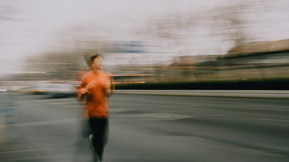 A person running on a street with motion blur